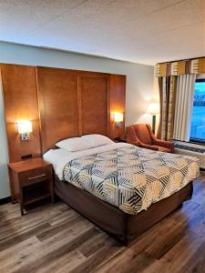 une chambre d'hôtel avec un lit et une chaise dans l'établissement Suites Catonsville MD Baltimore West, à Catonsville