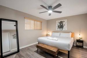 a bedroom with a bed with a ceiling fan and a mirror at Heart of Old Town Scottsdale in Scottsdale +17 photos