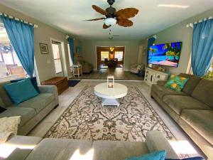 a living room with a couch and a table at Blue Heron House, Private 4 BR Waterfront w Heated Pool and Fire Pit in Ruskin