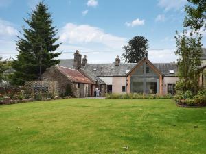 a house with a large lawn in front of it at Rowanlea in Muthill