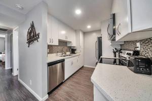 a kitchen with white cabinets and a counter top at Walk to Old Town Scottsdale in Scottsdale