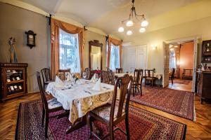 a dining room with a table and chairs at Willa Wiluszówka in Dębica