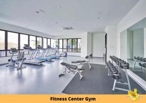 a fitness center with a bunch of treadms and chairs at Sinar Rasa Homestay at I-Soho, I-City in Shah Alam