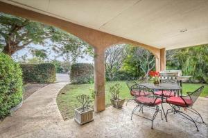 a patio with a table and chairs under a pavilion at Beautiful Spacious Home in Paradise in Waikoloa Village