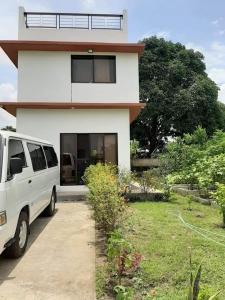 a white van parked in front of a house at Adama Farmhouse @ Hacienda San Benito in San Celestino