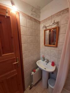 a bathroom with a sink and a toilet and a mirror at Apartment Boto - 20m from the sea in Smergo