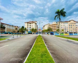 an empty street in a city with palm trees and buildings at RumahChantiqq at Ehsan waterpark, Port Dickson in Port Dickson