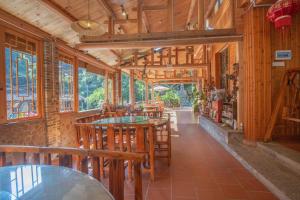 a restaurant with wooden walls and tables and windows at Nanjing Tulou Xinyuan HomeStay in Nanjing