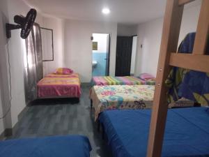 a room with three bunk beds and a hallway at Habitaciones Grupales in Playas