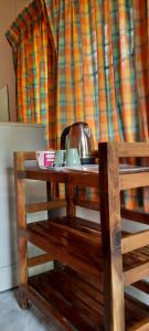 a wooden table with a tea kettle on top of it at Long Beach Garden Resort in Ko Lanta