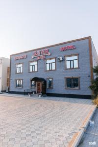 a building with a brick driveway in front of it at RUSH BUTIK in Atyraū