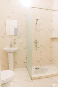 a bathroom with a shower and a toilet and a sink at RUSH BUTIK in Atyraū