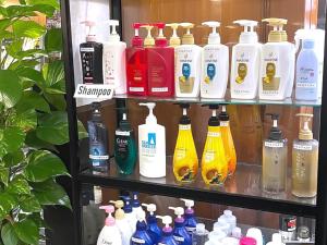 a shelf filled with lots of bottles of detergents at Hotel Abest Naha Kokusai Street in Naha