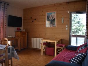 een kamer met een houten muur met een tafel en een televisie bij Appartement Font-Romeu-Odeillo-Via, 3 pièces, 6 personnes - FR-1-580-34 in Font Romeu Odeillo Via