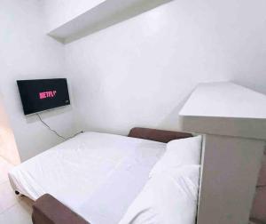 a small room with a bed and a tv at Sweden's Tiny Home, Studio Unit Condo in Manila