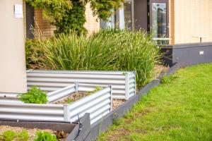 two raised garden beds in front of a house at Holiday Inn Melbourne Airport, an IHG Hotel in Melbourne