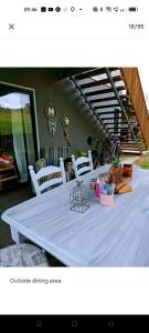 a table with white chairs and a white table cloth at Seventeen Mc Bean Scenic Getaway in Boonah