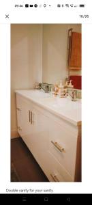 a bathroom with a white sink and a mirror at Seventeen Mc Bean Scenic Getaway in Boonah