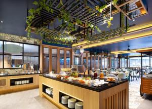 a restaurant with a buffet line with food at GLOW Mira Karon Beach in Karon Beach +45 photos