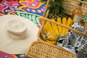 a basket of bananas and a hat on a table at The Funny Lion - El Nido in El Nido