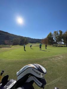 eine Gruppe von Menschen, die auf einem Golfplatz Golf spielen in der Unterkunft Horizon Pissouri Bay 1 bedroom apartment with communal pool in Pissouri