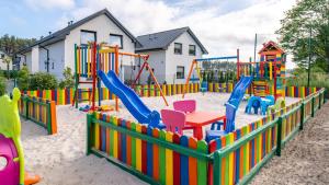 a playground with colorful play equipment in the sand at Turkusowy Klif in Jastrzębia Góra