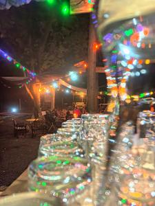 a row of wine glasses sitting on a table at night at Riverside Villas Nanyuki in Nanyuki