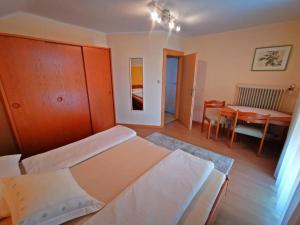 a bedroom with a bed and a dining room table at Haus Maria in Sankt Johann im Walde