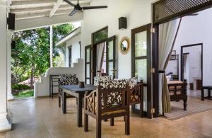 a dining room with a table and chairs at Why House in Unawatuna