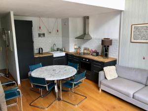 a kitchen with a table and chairs and a couch at Design loft in Chamonix Center in Chamonix