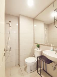 a bathroom with a toilet and a sink at Benson Tower Surabaya Apartment 2BR by Le Ciel Hospitality in Lontar