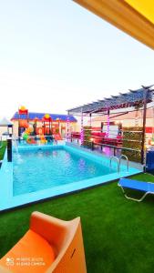 a large swimming pool with a playground in a building at شاليهات نبراس in Riyadh