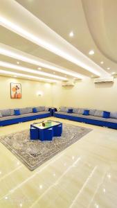 a large room with couches and a table in the middle at شاليهات نبراس in Riyadh
