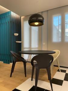 a dining room with a table and two chairs at A10 Palazzo Marconi Apartment in San Giovanni Valdarno