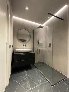 a bathroom with a sink and a mirror at A10 Palazzo Marconi Apartment in San Giovanni Valdarno