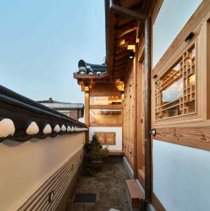 a balcony of a house with wooden walls at Luxury hanok with private bathtub - SN13 in Seoul