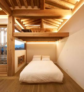 a bedroom with a large white bed in a room at Luxury hanok with private bathtub - SN13 in Seoul