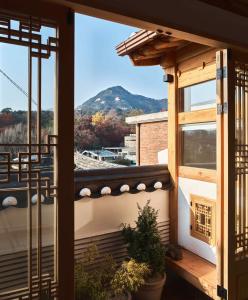 a balcony with a view of a mountain at Luxury hanok with private bathtub - SN13 in Seoul