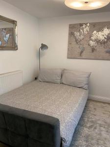 a bedroom with a bed with a map on the wall at Homely Beachside Apartment in Newquay Town Centre! in Newquay