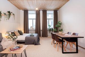 a living room with a bed and a table at Bali house Vilnius in Vilnius