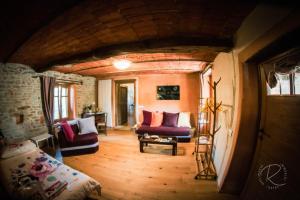 a living room with two couches and a table at Cascina Boschetto in Saliceto