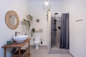 a bathroom with a sink and a toilet and a shower at Bali house Vilnius in Vilnius