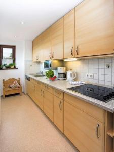 a kitchen with wooden cabinets and a counter top at Ferienwohnung Baldauf in Oberstdorf