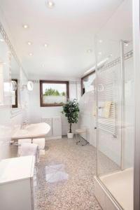 a white bathroom with a sink and a shower at Ferienwohnung Baldauf in Oberstdorf