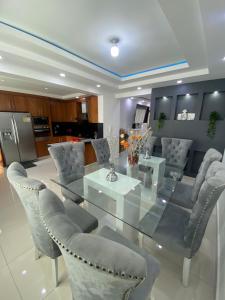 a dining room with a glass table and chairs at Fully equipped apartment with sea view in La Viva