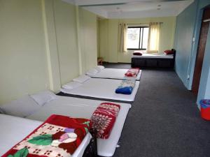 מיטה או מיטות בחדר ב-Hotel Sunrise View