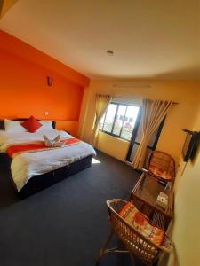 a hotel room with a bed and a window at Hotel Sunrise View in Nagarkot