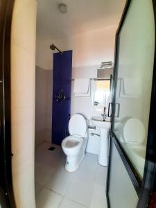 a bathroom with a toilet and a sink at Hotel Sunrise View in Nagarkot