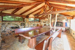 a dining room with a wooden table and benches at Barbic in Medulin
