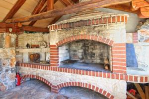 a large brick fireplace in a room with at Barbic in Medulin